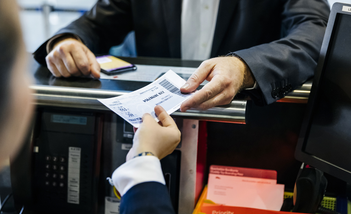 Businessman getting his boarding pass at check-in counter
