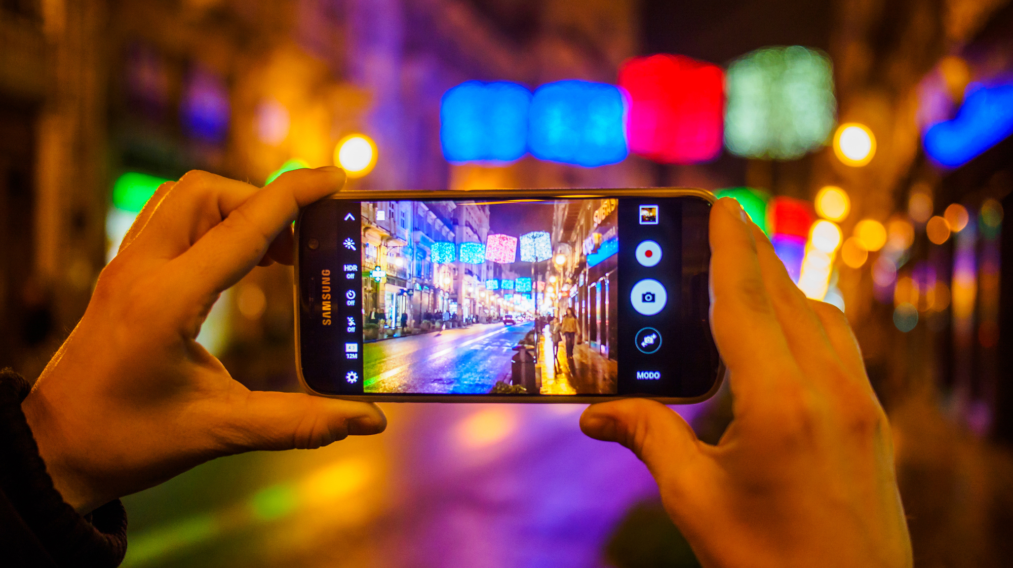 Christmas in Spain – Woman hands photographing Christmas lights