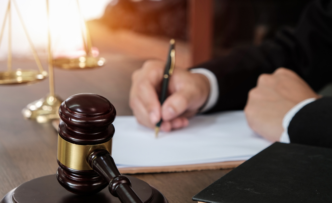 Law, lawyer attorney and justice concept, male lawyer or notary working on a documents and report of the important case in the law firm,bangkok,thailand