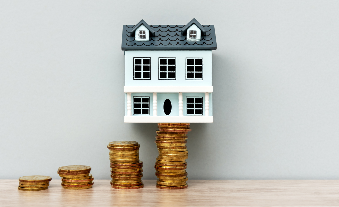 House Model on Top of Stack of Coins