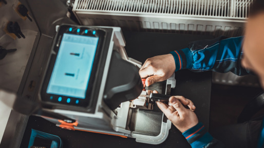 Man copying car key with key copy machine