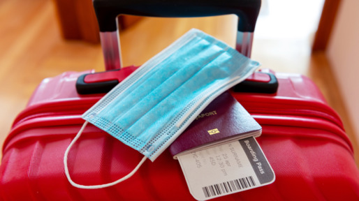 Face protection mask over passport and boarding ticket