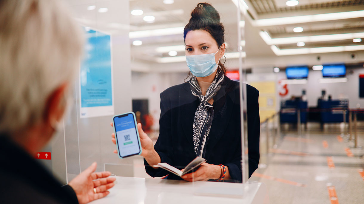 Handling agent at the airport checking covid passport