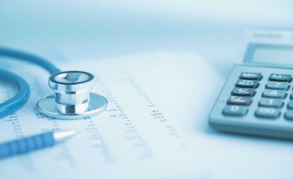 Close up of calculator, data and stethoscope