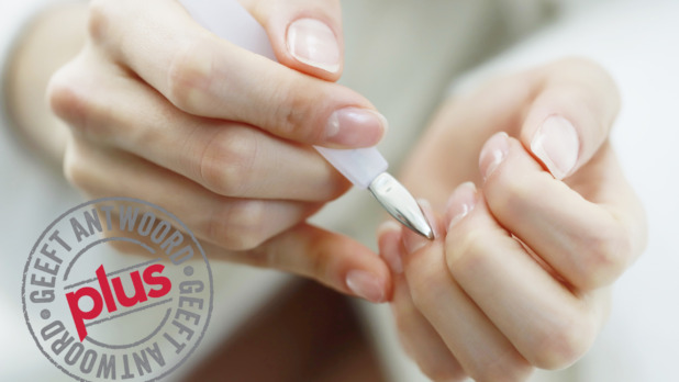 Woman using cuticle pusher