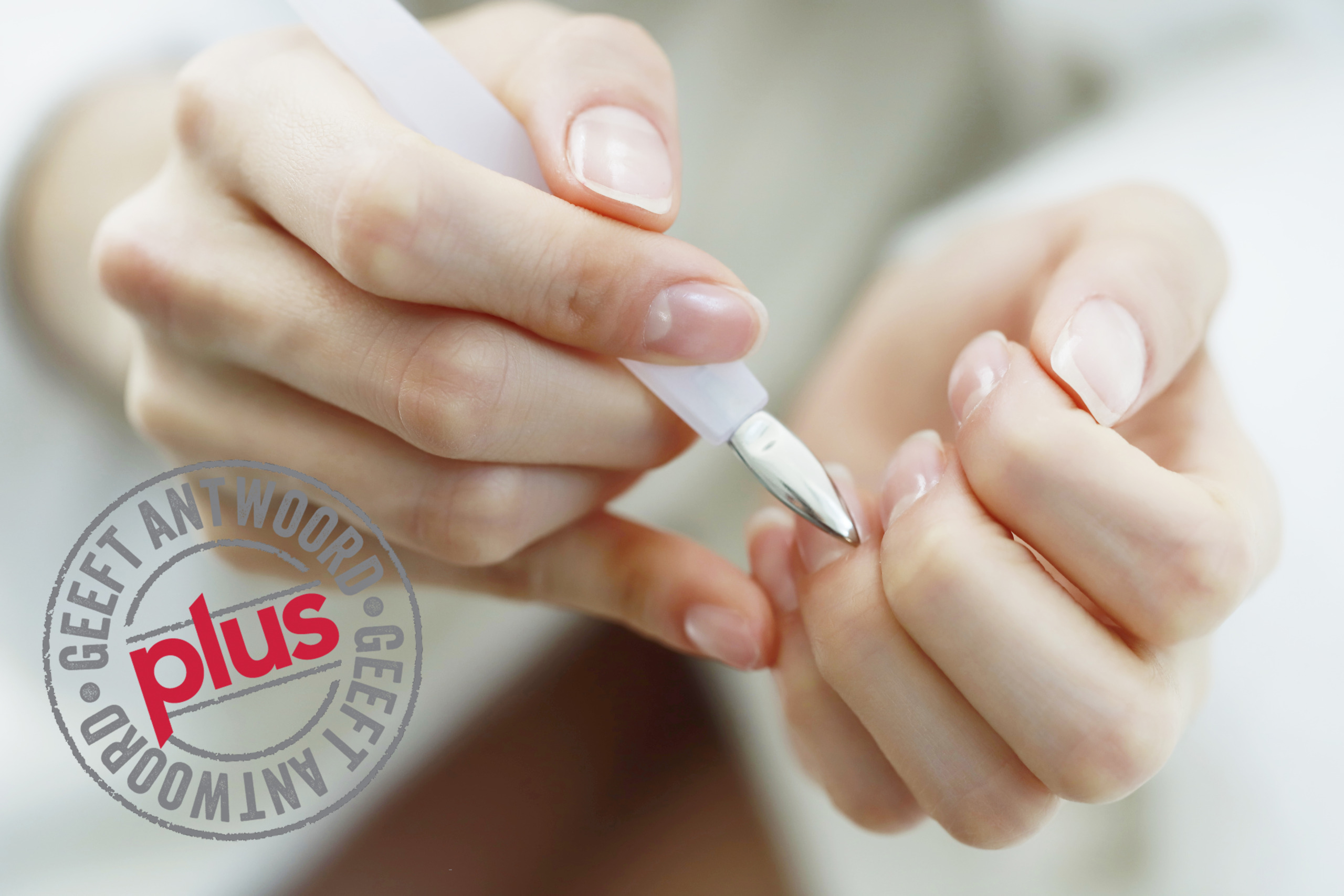 Woman using cuticle pusher