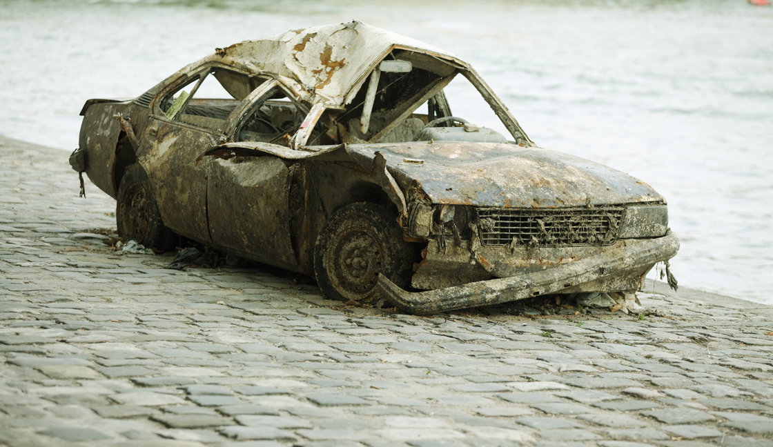Wrecked car on waterfront
