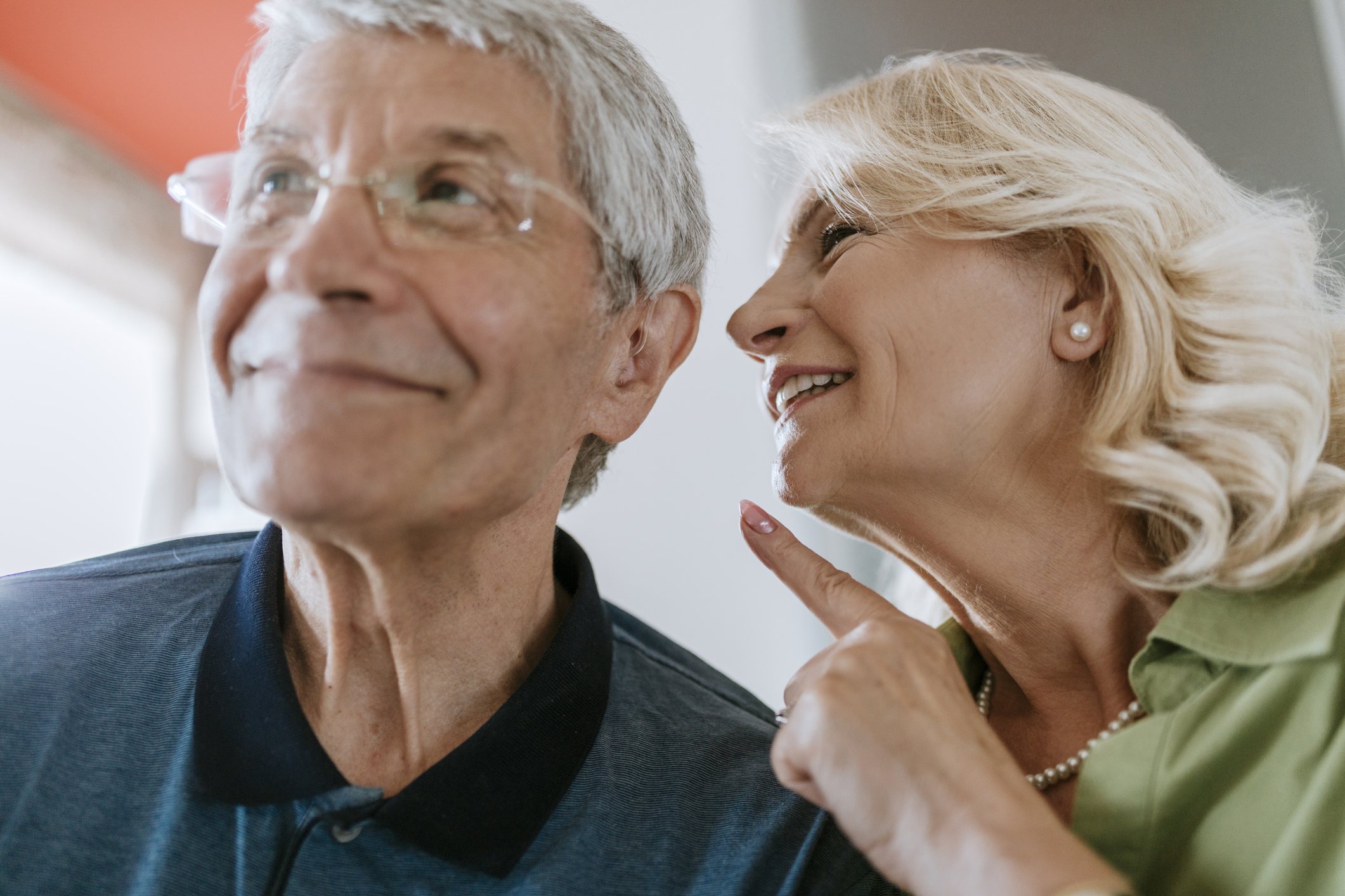 Senior woman talking to husband with hearing aid