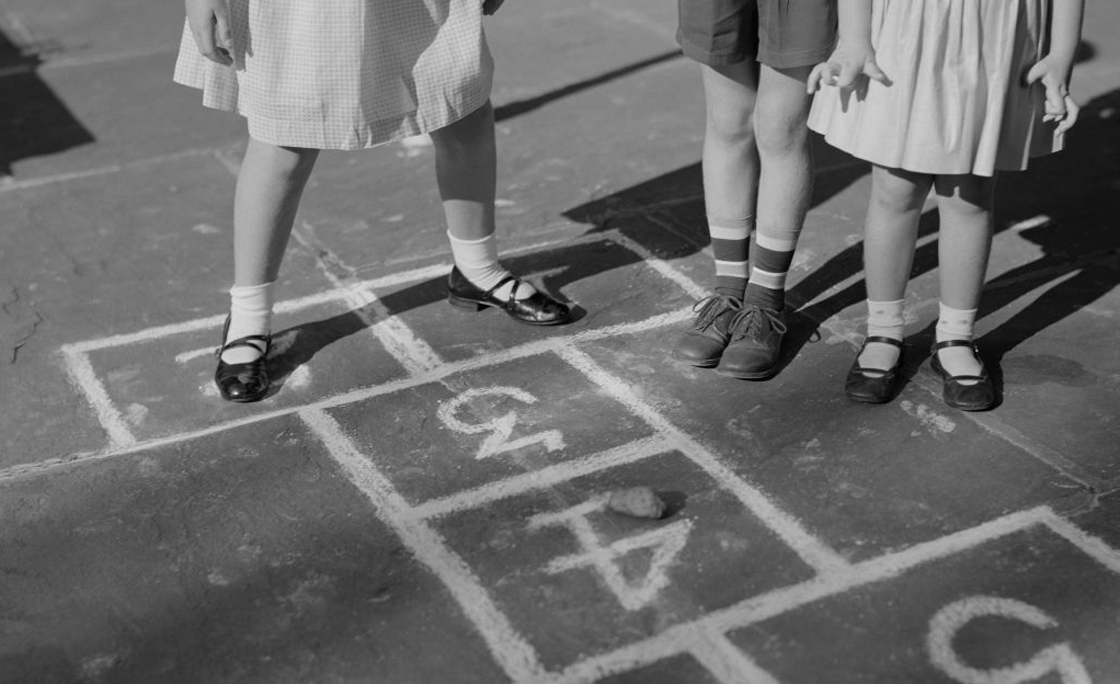 Children playing hopscotch game