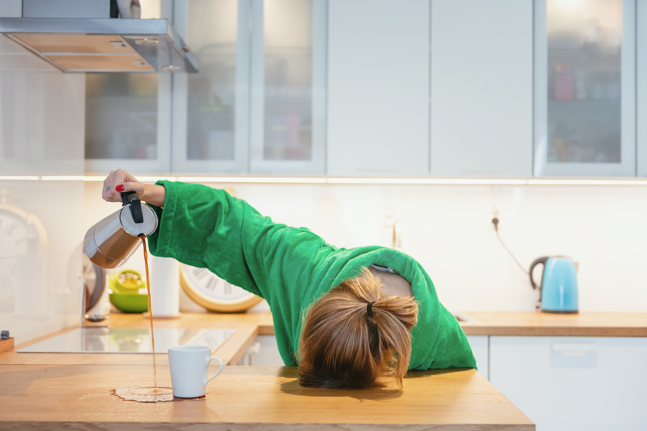 Tired Woman Trying To Drink Morning Coffee And Sleeping On The Table