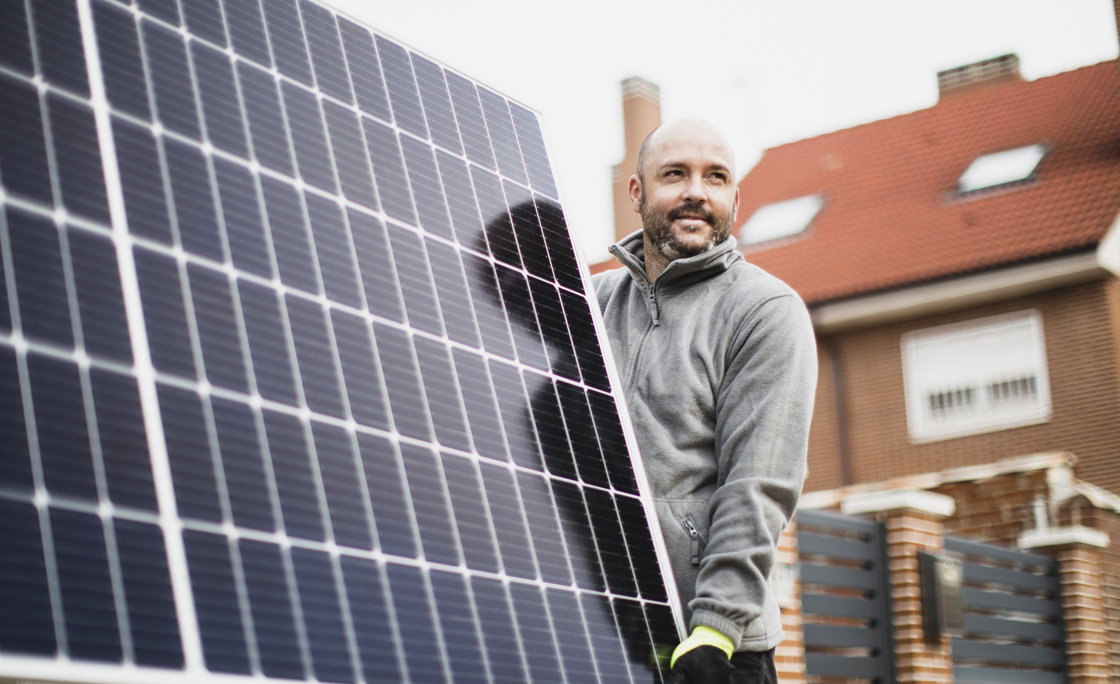 construction worker installing solar panels