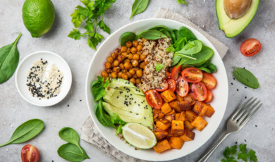 healhty vegan lunch bowl. Avocado, quinoa, sweet potato, tomato, spinach and chickpeas vegetables salad