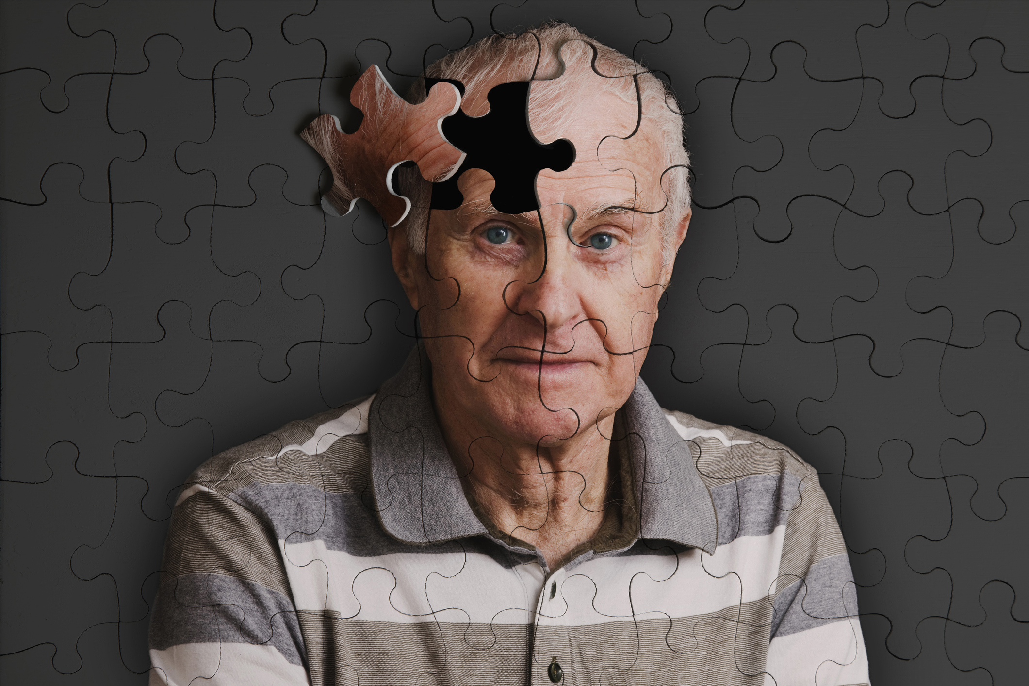 Jigsaw puzzle, of senior man, falling apart