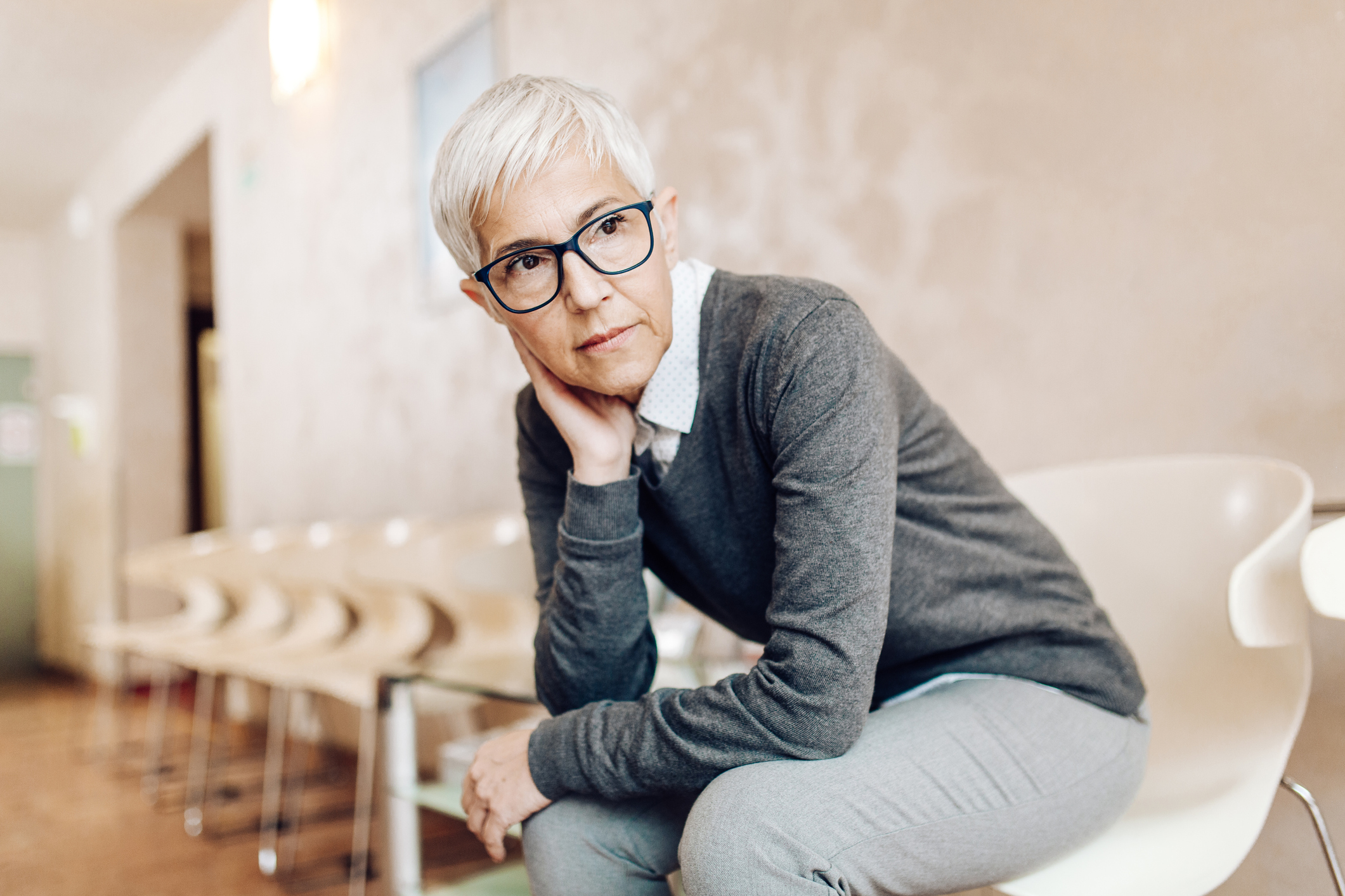 Worried mature woman waiting for her doctor at the medical clinic