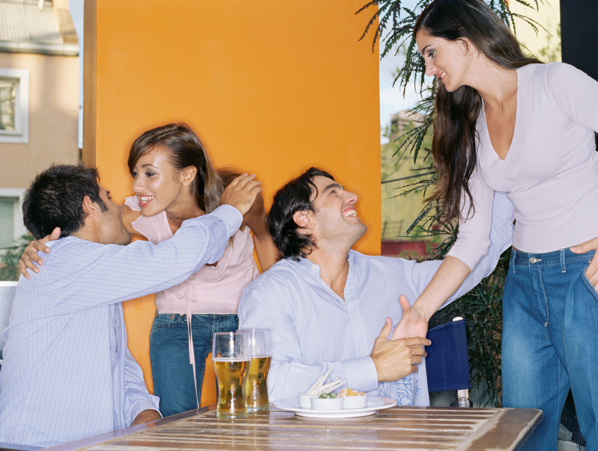 Friends greeting each other in a bar