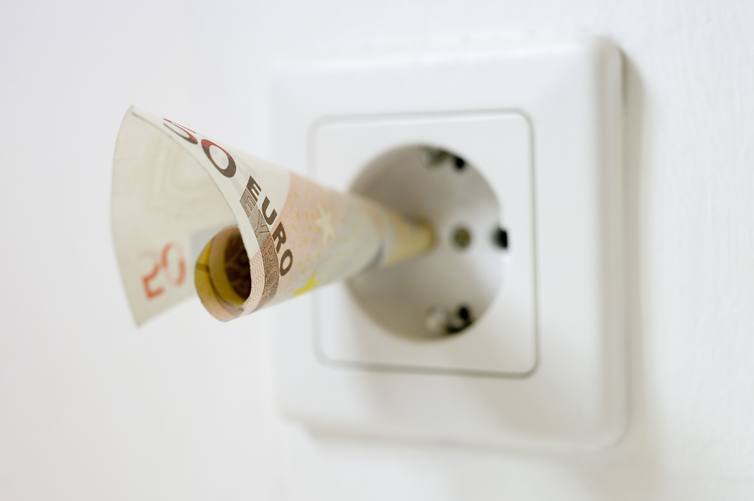 50 euro note kept into electrical socket, close up