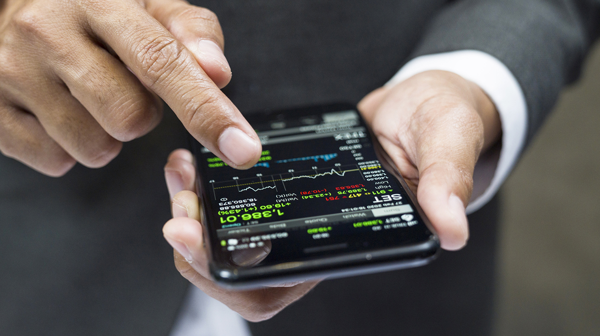 Manager buying cryptocurrency through mobile phone app