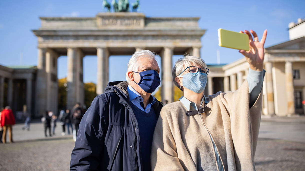 Couple taking selfies in front of famous Brandenburg Gate