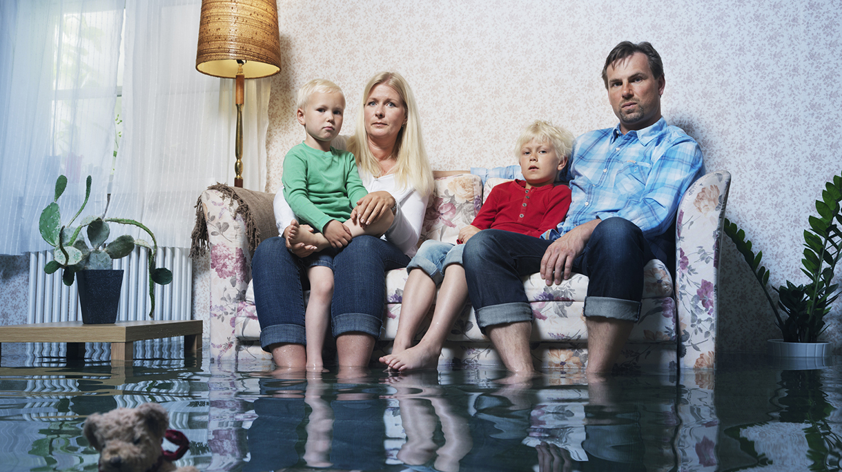 family in sofa in flooded room