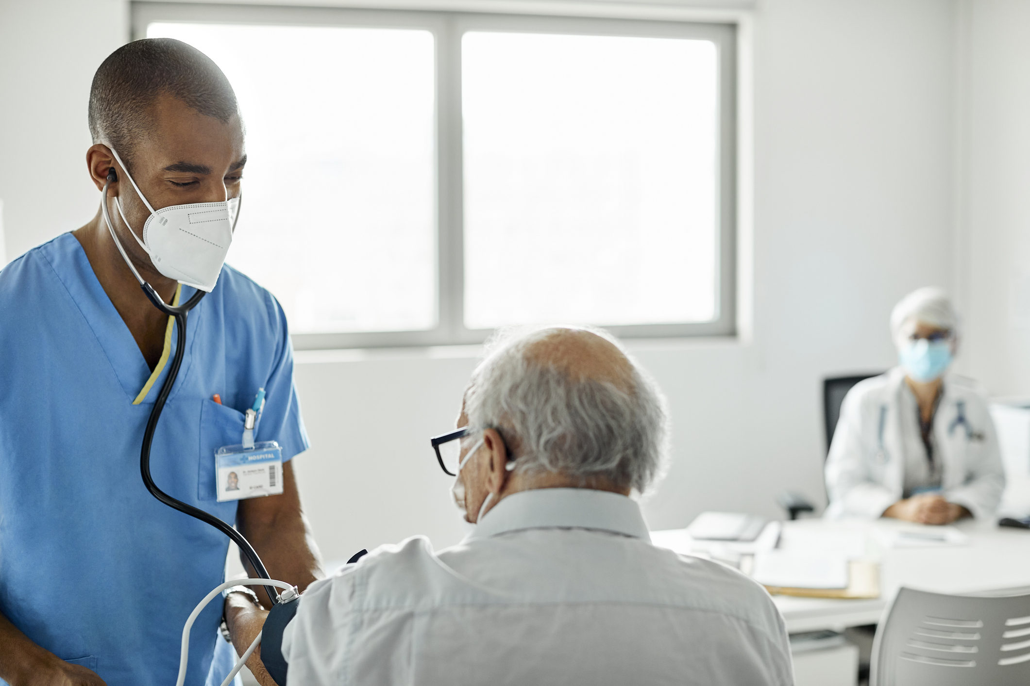 Nurse checking patient in clinic during COVID-19