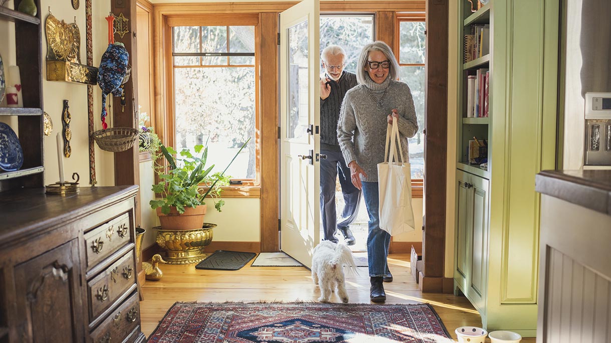Man and woman arriving home with shopping