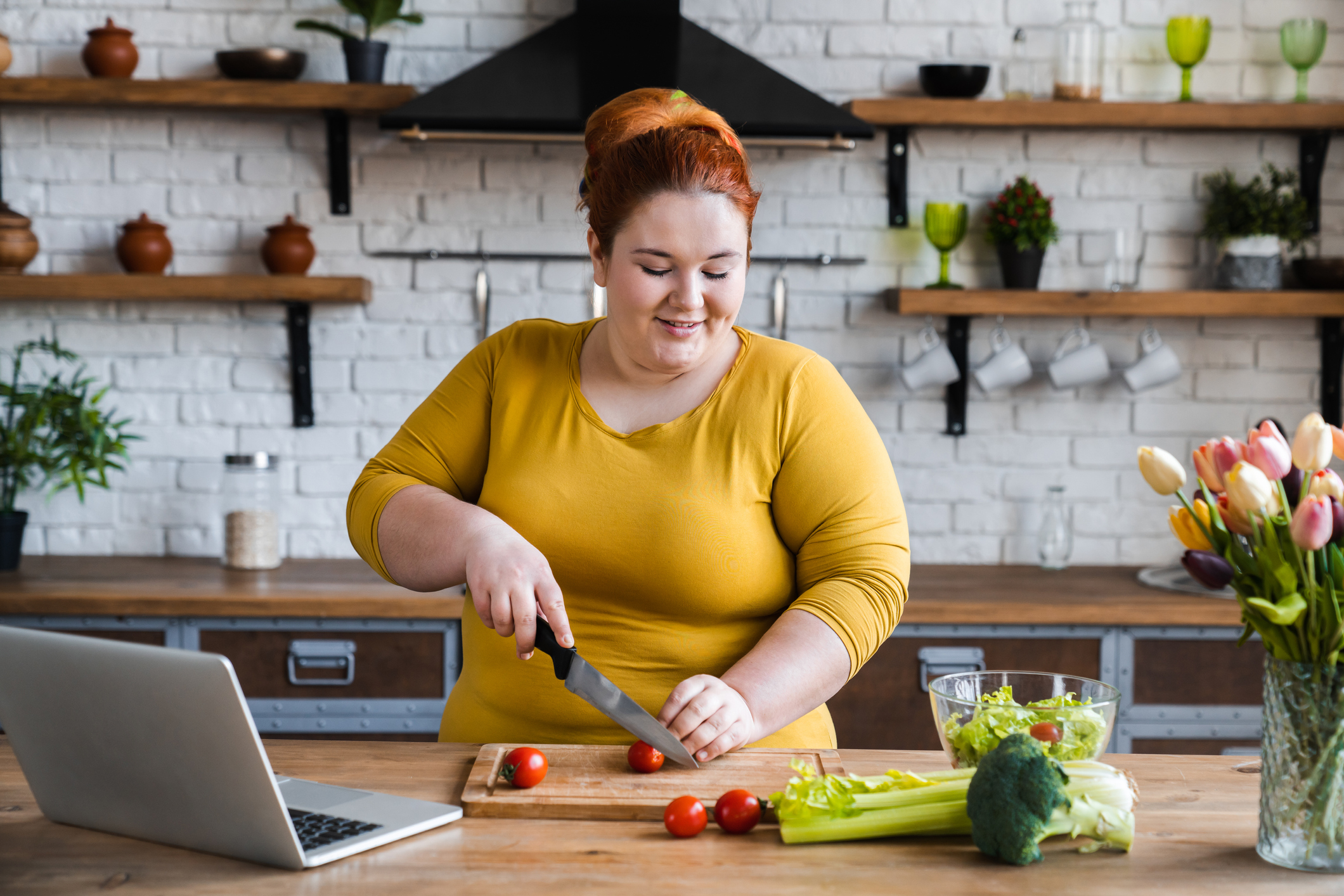 Plus size , caucasian woman learning to make salad and healthy food from social media,Social distancing, stay at home concept