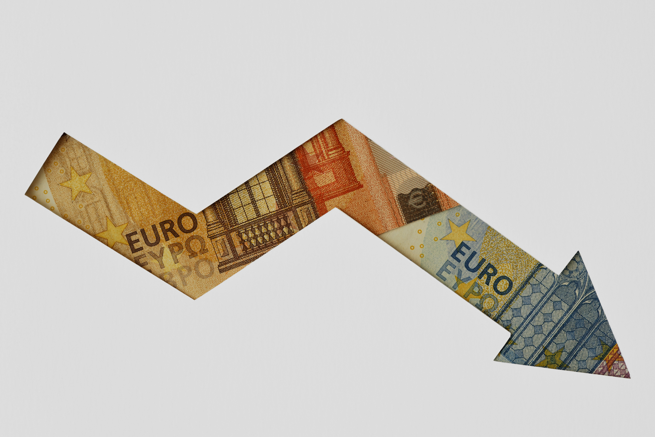 Downward arrow made of euro banknotes on white background – Concept of downward trend of euro currency