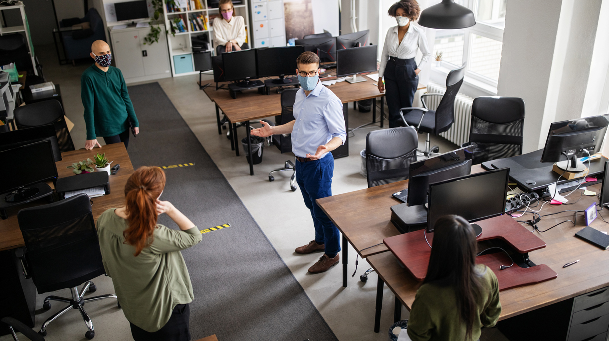 Staff meeting in office with social distancing