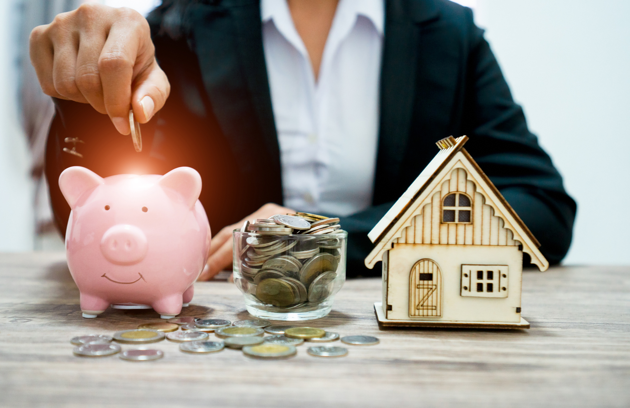 Piggy bank and stacking gold coins with increase and There is light at the coin. Saving money for buy a new house and Investor  , Saving money for buy a new house and loan for plan business investment for real estate in the future concept.