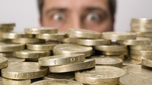 Man looking at stack of coins