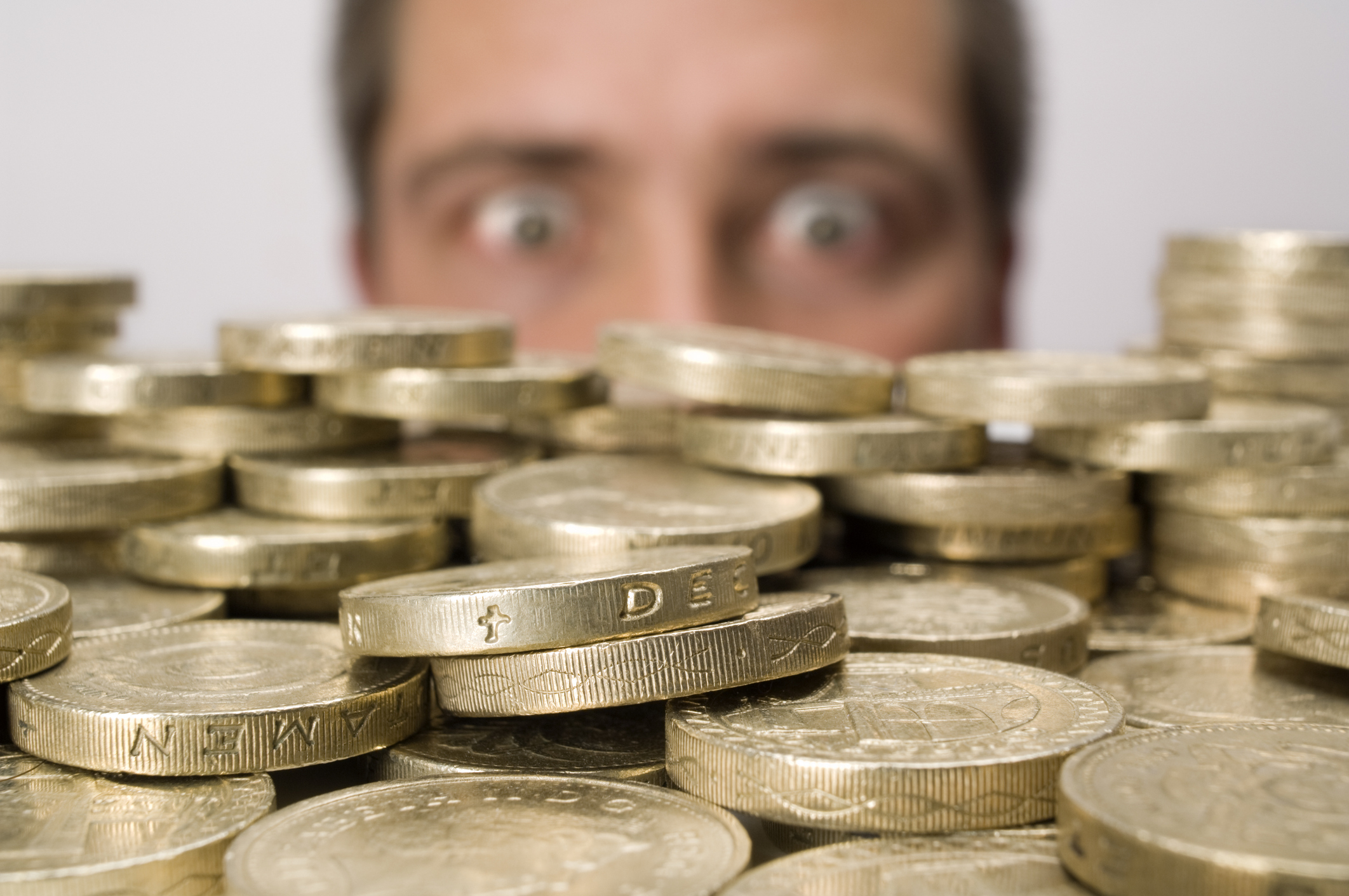 Man looking at stack of coins