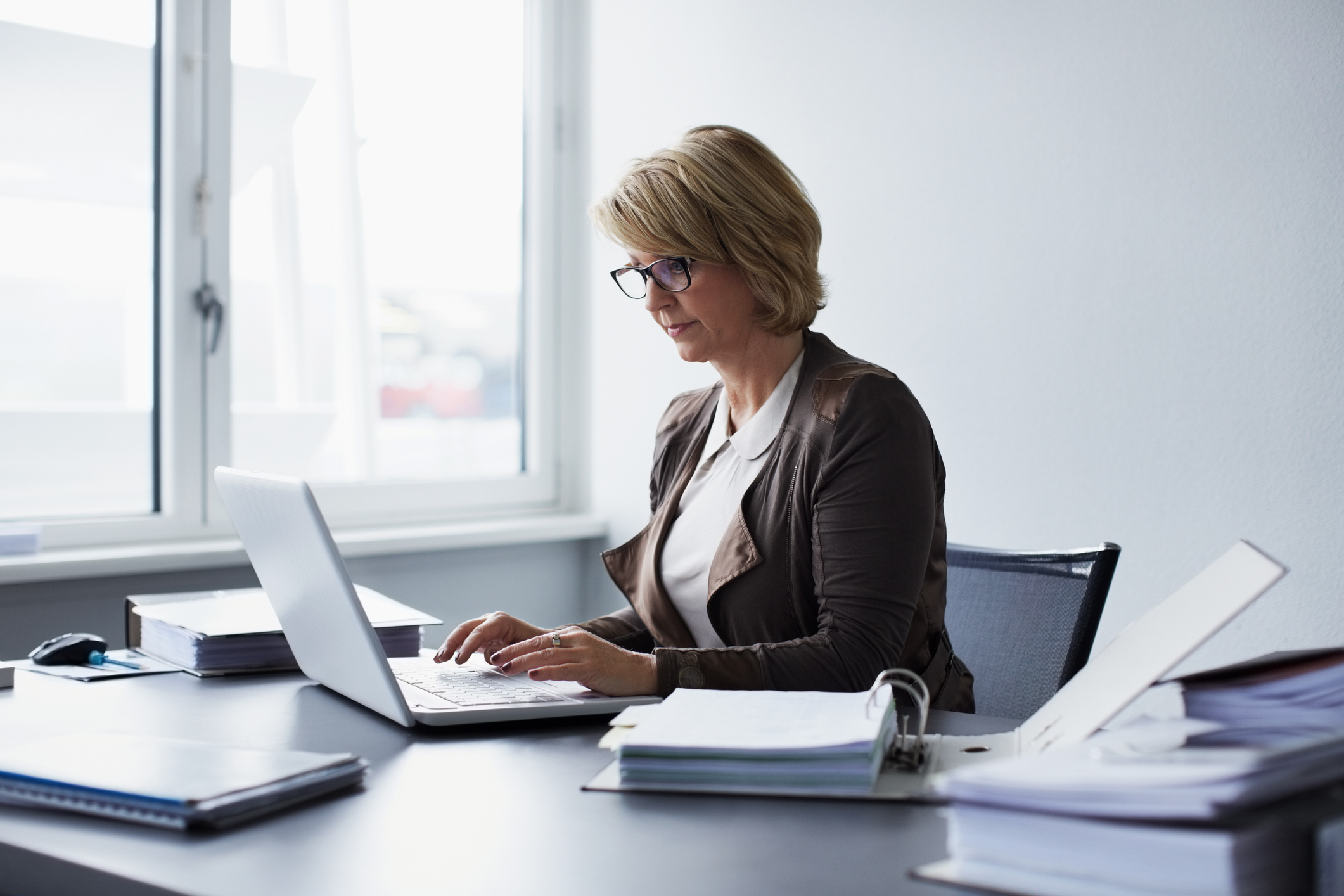 Businesswoman using laptop in office