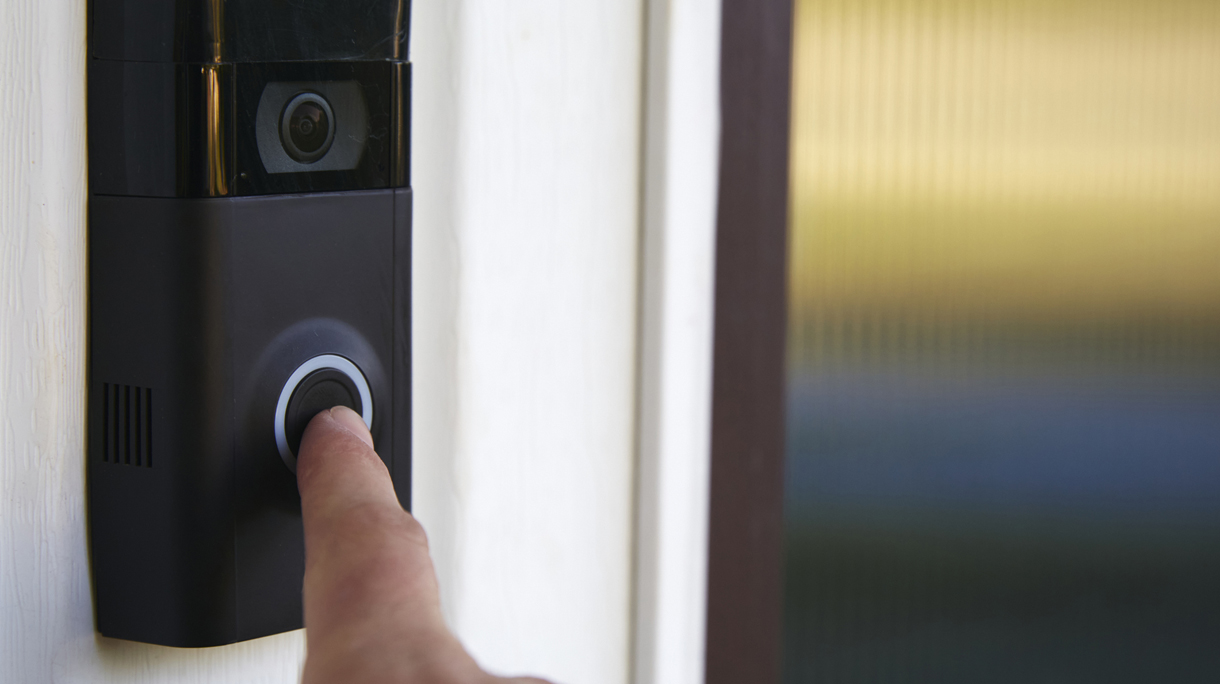 Close up POV shot of a person ringing a smart doorbell