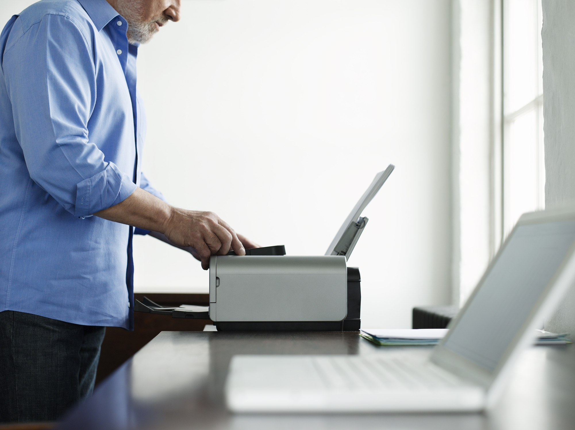 Man Using Computer Printer