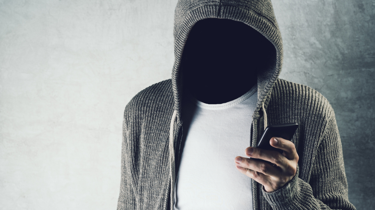 Digital Composite Image Of Faceless Man Using Smart Phone Against Wall