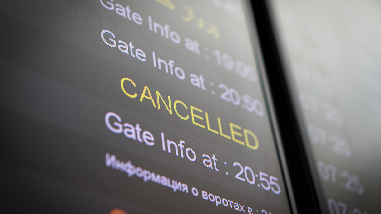 Flight cancelled illuminated on airport arrivals board