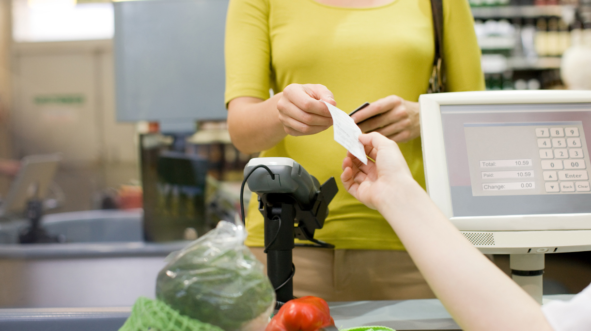 Cashier handing receipt to customer