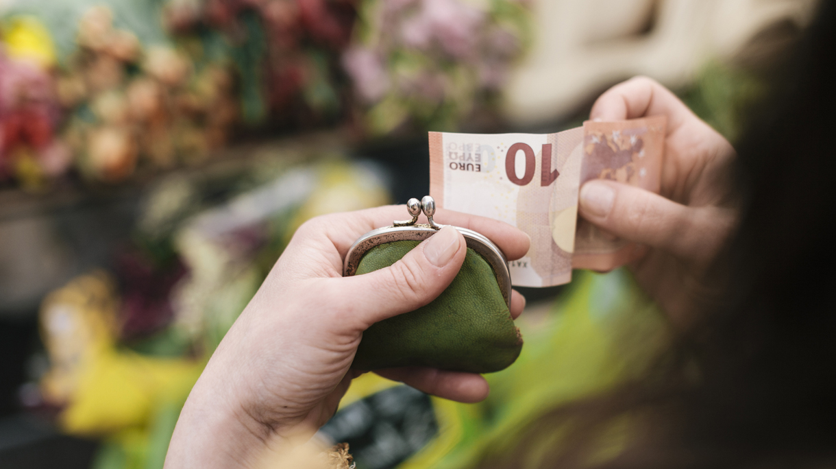 Woman paying for Flowers with 10 Euro Bill