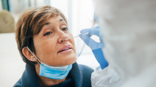 Close up of the face of a senior female patient being tested for Covid-19