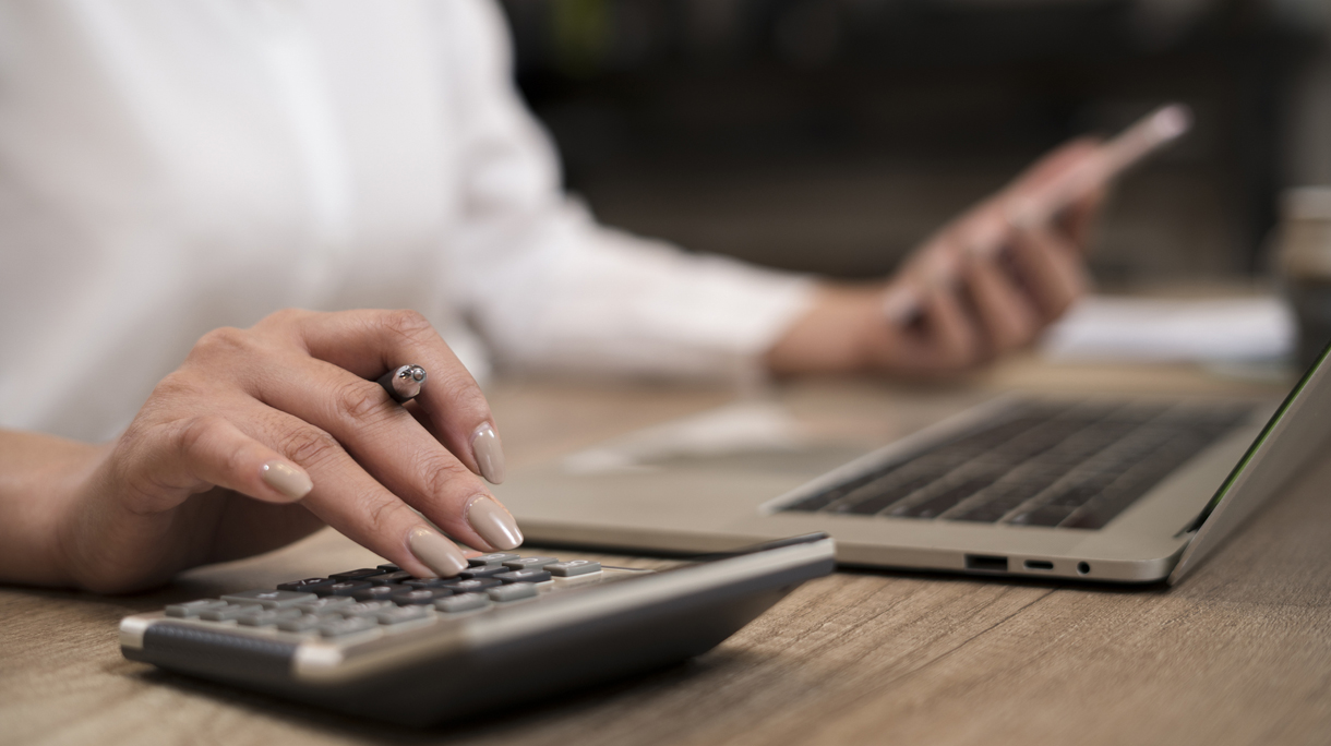 Savings, finances and economy concept.Close up hand of businesswoman accountant or banker making calculations.
