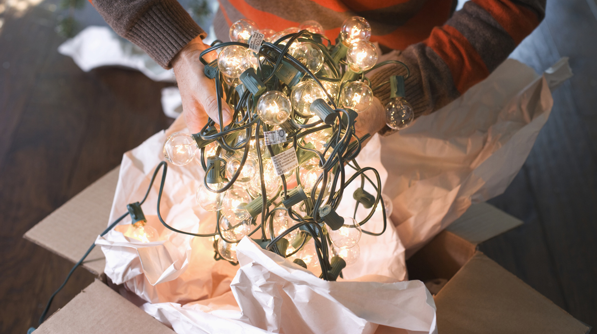 Man Holding Tangled String of Christmas Lights