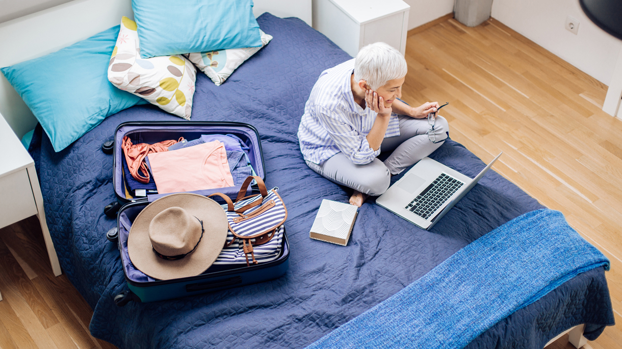 Happy mature woman exploring her travel destination before going on a journey