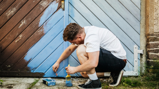 Man Painting His Garden Gate Blue