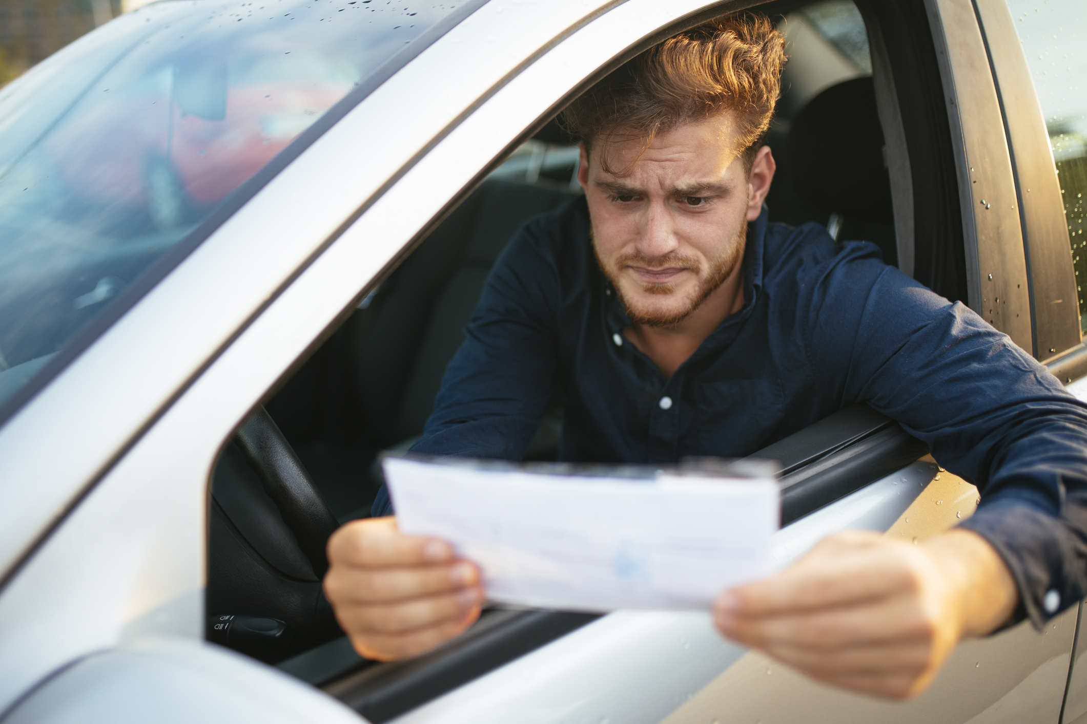 Upset young man gets parking ticket