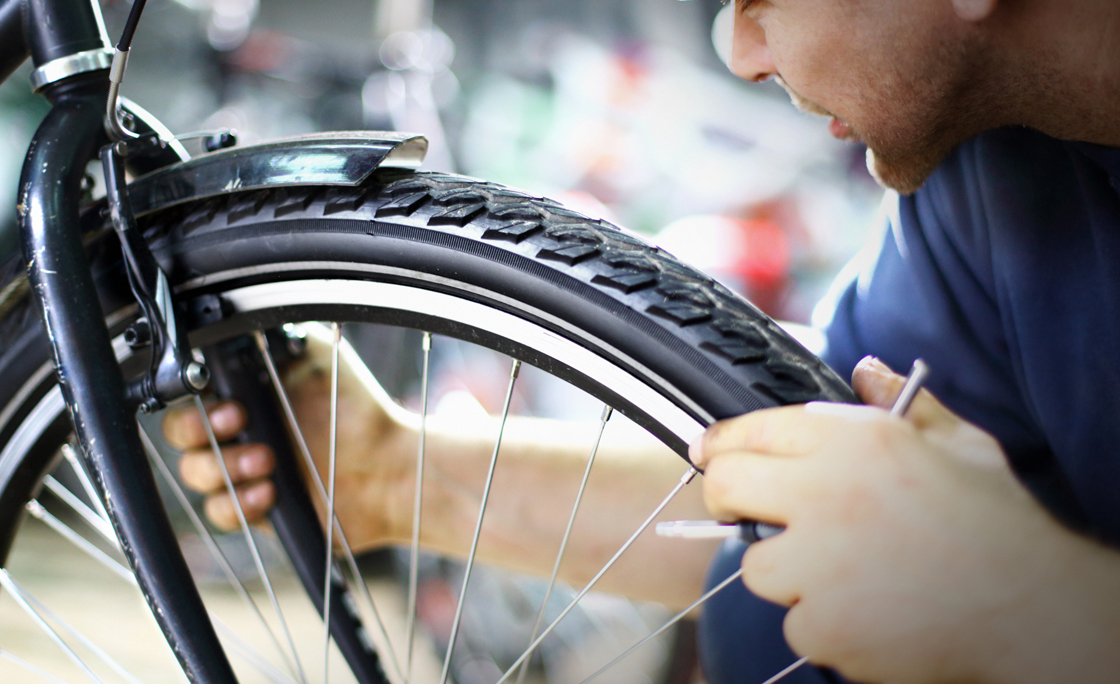 Bike mechanic repairing a wheel