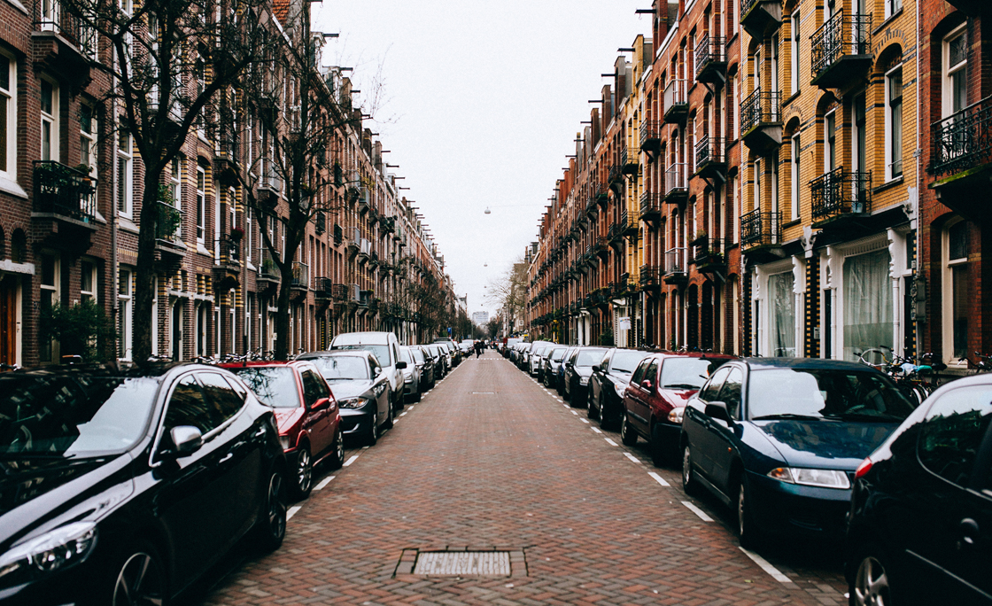 Cars Parked On Street Amidst Buildings Against Sky