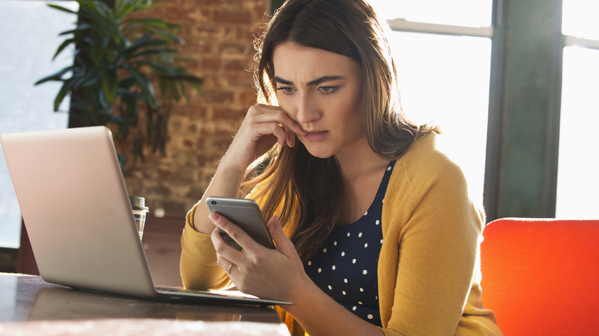 Stressed Caucasian businesswoman using cell phone