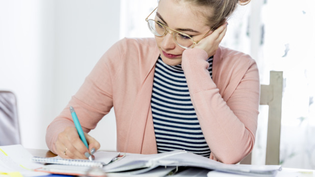 Female student learning and working at home.