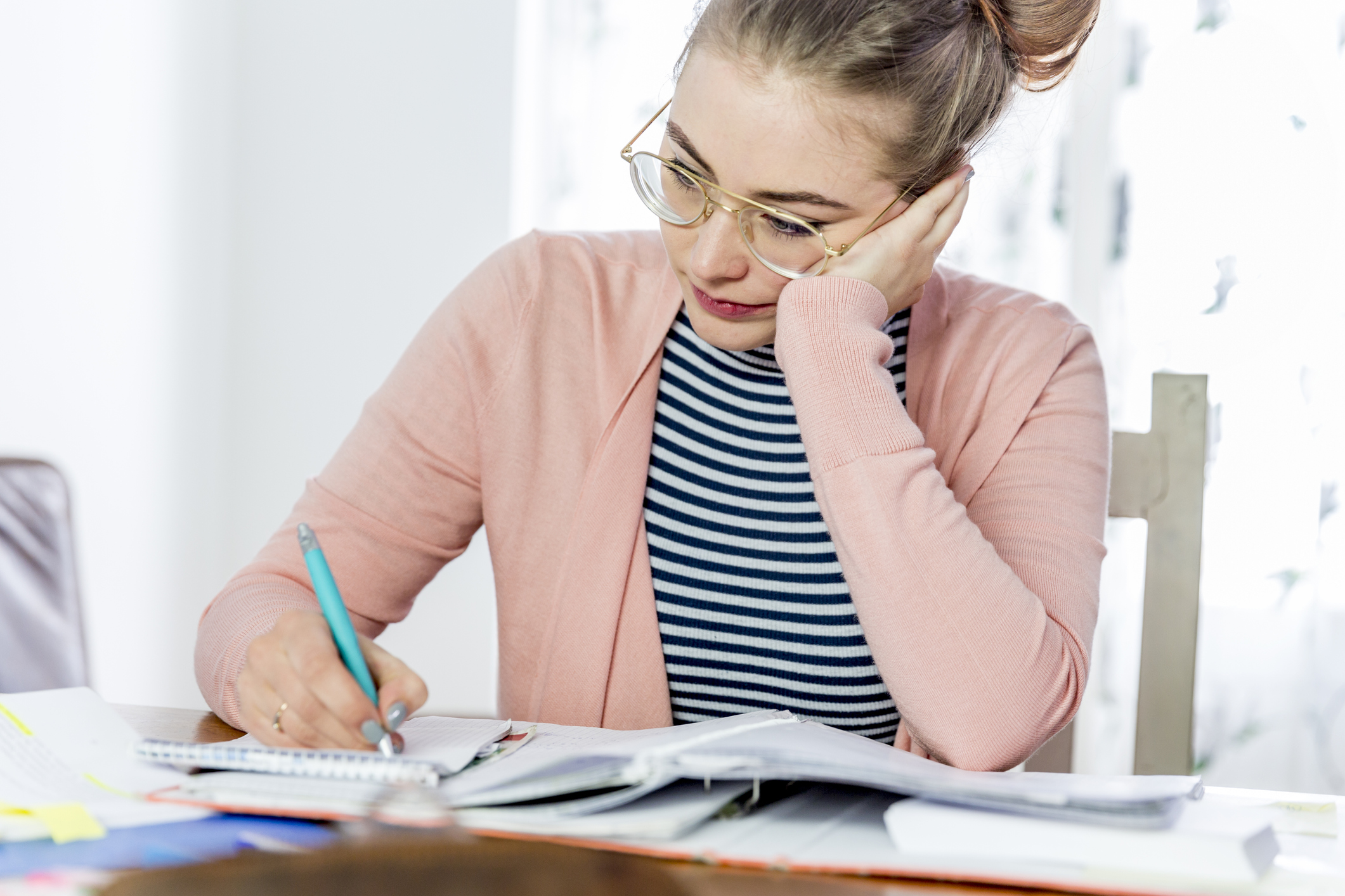 Female student learning and working at home.