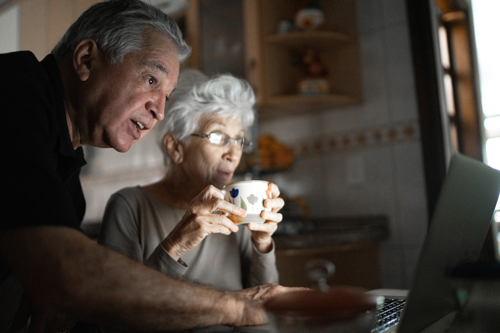 Senior couple using laptop at home